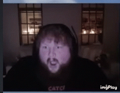 A Man With A Beard Is Wearing A Black Hoodie That Says Catch On The Front GIF
