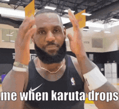 A Man With A Beard Is Wearing A Black Nike Tank Top And A Necklace . GIF