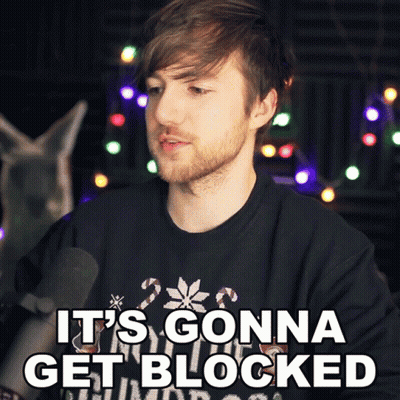 A Man With A Beard Is Wearing A Black Shirt That Says " It 'S Gonna Get Blocked " GIF