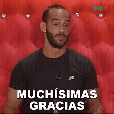 A Man With A Beard Is Wearing A Black Shirt That Says Muchisimas Gracias On It GIF