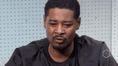 A Man With A Beard Is Wearing A Black Shirt That Says Nike GIF