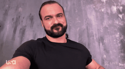 A Man With A Beard Is Wearing A Black Shirt That Says Usa On The Arm GIF