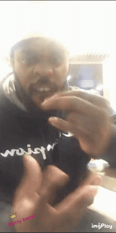 A Man With A Beard Is Wearing A Black Shirt That Says ' Woisq ' On It GIF