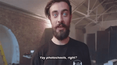 A Man With A Beard Is Wearing A Black Shirt That Says " Yay Photoshoots Right " . GIF