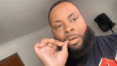 A Man With A Beard Is Wearing A Black Shirt With The Letter A On It GIF
