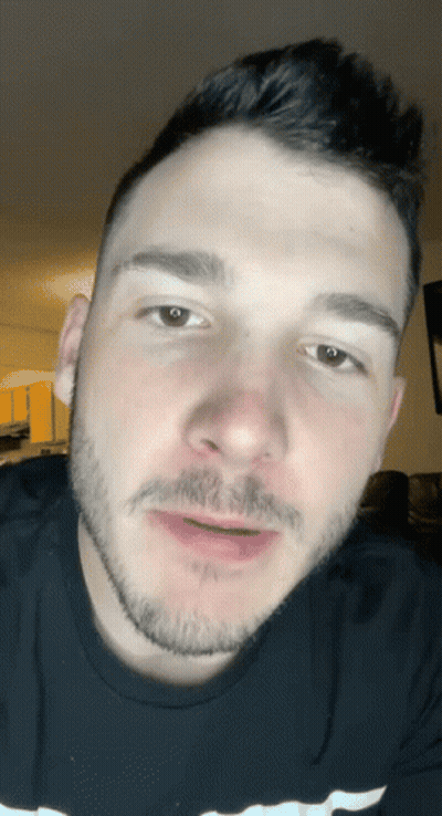 A Man With A Beard Is Wearing A Black Shirt With The Word Champion On It GIF