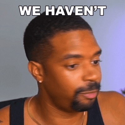 A Man With A Beard Is Wearing A Black Tank Top And Has The Words " We Haven 'T " Written On His Face GIF