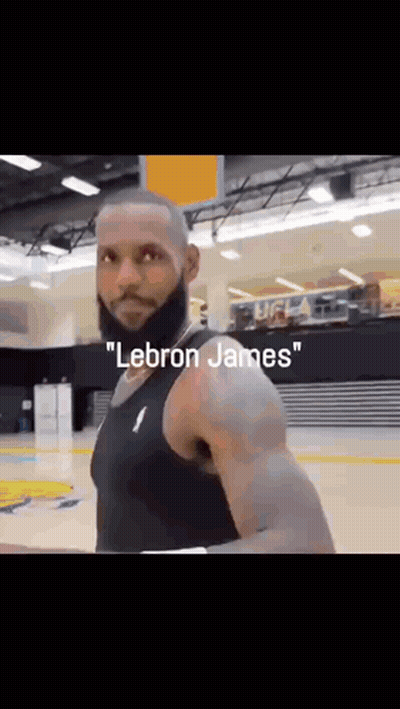 A Man With A Beard Is Wearing A Black Tank Top With The Word Lebron James On It . GIF