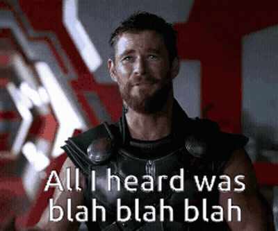 A Man With A Beard Is Wearing A Black Vest With The Words All I Heard Was Blah Blah Blah On It GIF