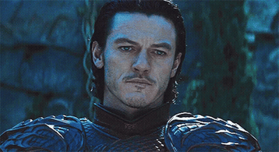 A Man With A Beard Is Wearing A Blue And Black Armor GIF
