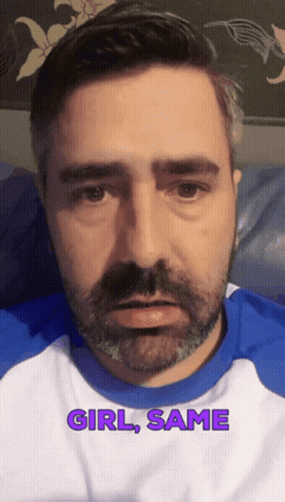 A Man With A Beard Is Wearing A Blue And White Shirt With The Words Girl Same On It GIF
