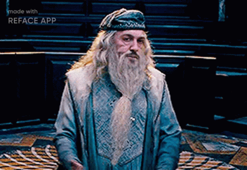 A Man With A Beard Is Wearing A Blue Hat And A Blue Coat .. GIF