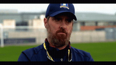 A Man With A Beard Is Wearing A Blue Hat That Says ' Ireland ' On It GIF