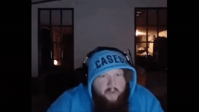 A Man With A Beard Is Wearing A Blue Hoodie And Headphones And Says `` Yo What ? '' GIF