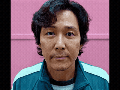 A Man With A Beard Is Wearing A Blue Jacket GIF