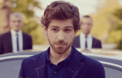 A Man With A Beard Is Wearing A Blue Jacket And A Blue Shirt GIF