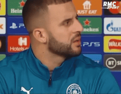 A Man With A Beard Is Wearing A Blue Jacket And Talking To Someone . GIF