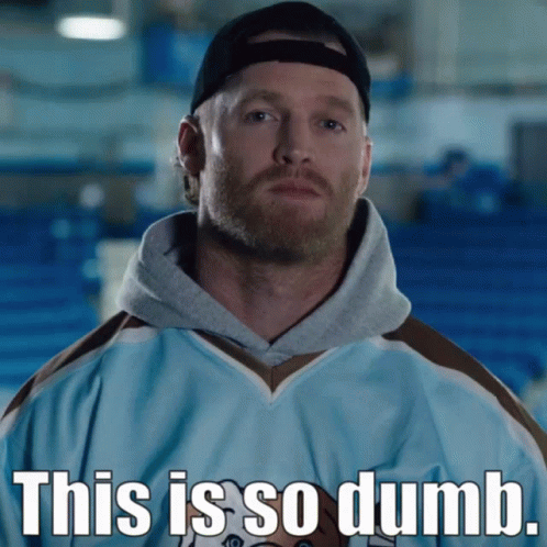 A Man With A Beard Is Wearing A Blue Jersey That Says This Is So Dumb On The Front GIF