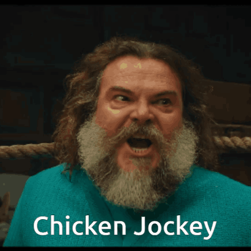 A Man With A Beard Is Wearing A Blue Shirt That Says " Chicken Jockey " GIF