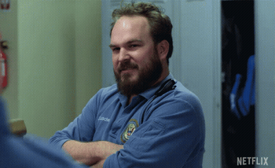 A Man With A Beard Is Wearing A Blue Shirt That Says J. Richard GIF