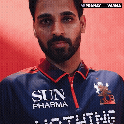 a man with a beard is wearing a blue shirt that says sun pharma