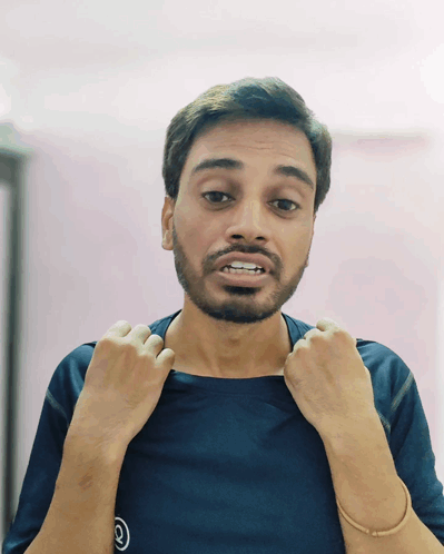 A Man With A Beard Is Wearing A Blue Shirt With The Number 2 On The Front GIF