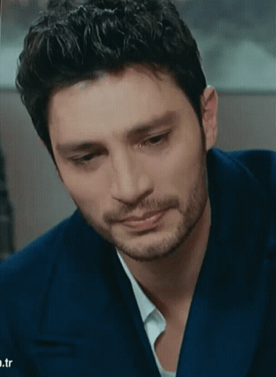 A Man With A Beard Is Wearing A Blue Suit And White Shirt GIF