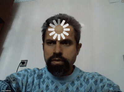 A Man With A Beard Is Wearing A Blue Sweater And Has A Spinning Wheel On His Head GIF