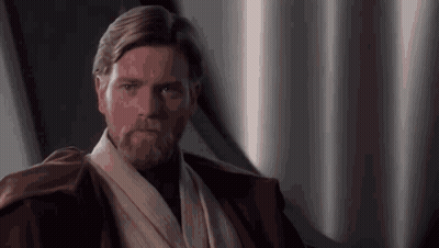 A Man With A Beard Is Wearing A Brown Jacket And A White Scarf Around His Neck . GIF