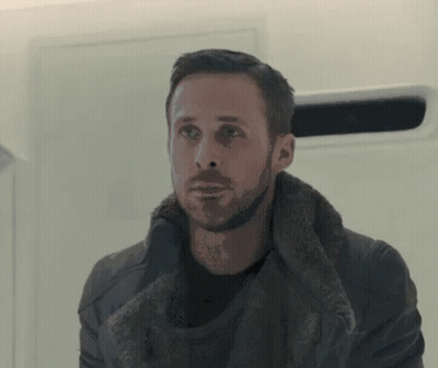 A Man With A Beard Is Wearing A Fur Coat And A Black Shirt . GIF