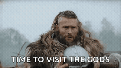 A Man With A Beard Is Wearing A Fur Coat And Holding A Helmet And Says `` Time To Visit The Gods '' . GIF