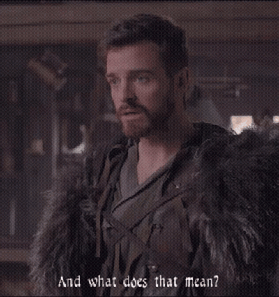 a man with a beard is wearing a fur coat and says " and what does that mean "