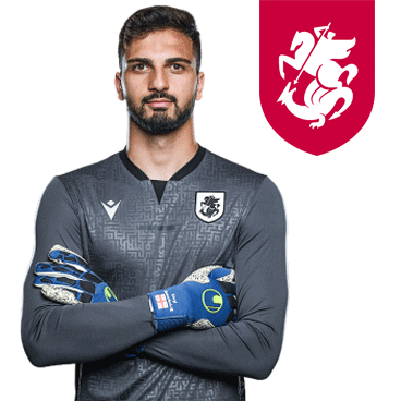 A Man With A Beard Is Wearing A Gray Shirt And Blue Gloves With A Red Shield With A Horse On It GIF