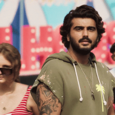 A Man With A Beard Is Wearing A Green Hoodie With A Palm Tree On It GIF