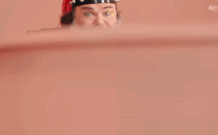 A Man With A Beard Is Wearing A Green Jacket And A Red Hat And Says Peaches Peaches GIF
