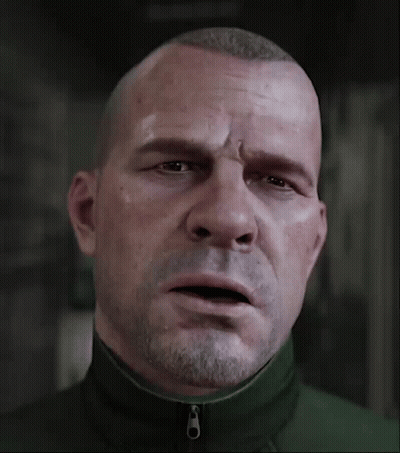 A Man With A Beard Is Wearing A Green Jacket With A Zipper On The Front GIF