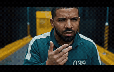A Man With A Beard Is Wearing A Green Jacket With The Number 039 On The Front GIF