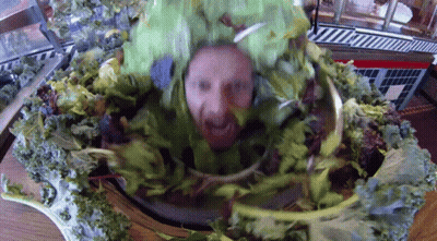 A Man With A Beard Is Wearing A Green Lettuce Costume GIF