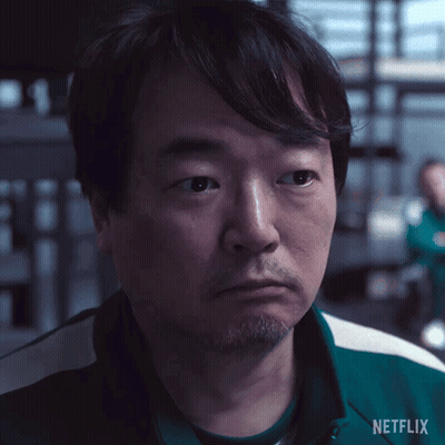 A Man With A Beard Is Wearing A Green Netflix Shirt . GIF