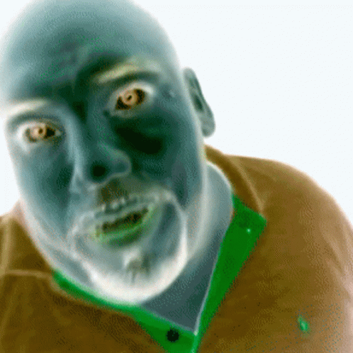 A Man With A Beard Is Wearing A Green Shirt GIF