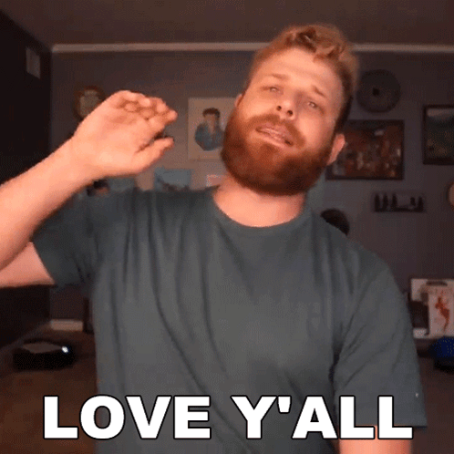 A Man With A Beard Is Wearing A Green Shirt That Says Love Y All GIF