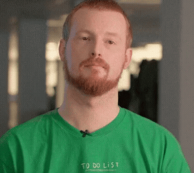 A Man With A Beard Is Wearing A Green T-Shirt That Says To Do List GIF