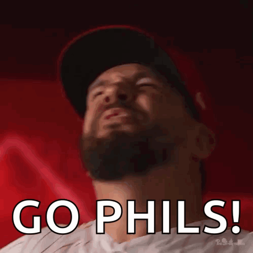 A Man With A Beard Is Wearing A Hat And Says Go Phils ! GIF