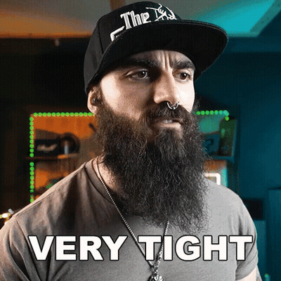 A Man With A Beard Is Wearing A Hat That Says Very Tight On It GIF