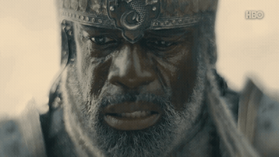 a man with a beard is wearing a helmet with a dragon on it