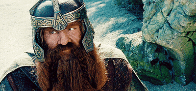 A Man With A Beard Is Wearing A Helmet With The Letter X On It GIF
