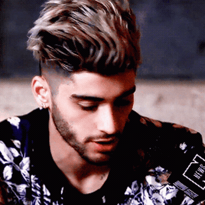 A Man With A Beard Is Wearing A Jacket With A Floral Pattern GIF
