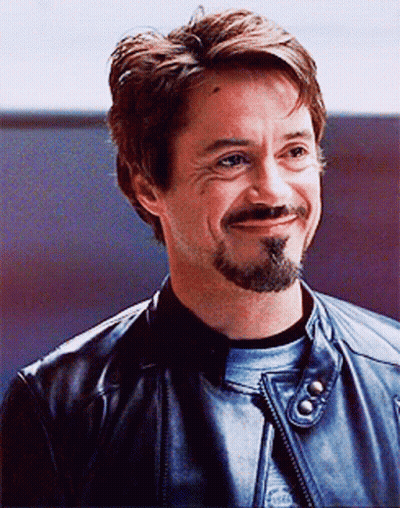 A Man With A Beard Is Wearing A Leather Jacket GIF