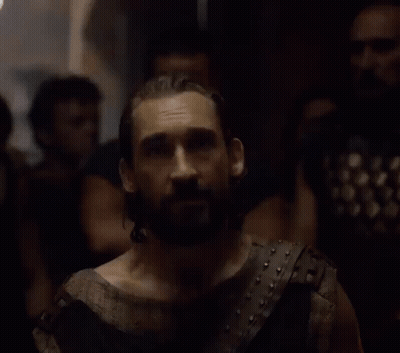 A Man With A Beard Is Wearing A Leather Vest GIF