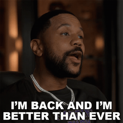 A Man With A Beard Is Wearing A Necklace And Says I 'M Back And I 'M Better Than Ever GIF